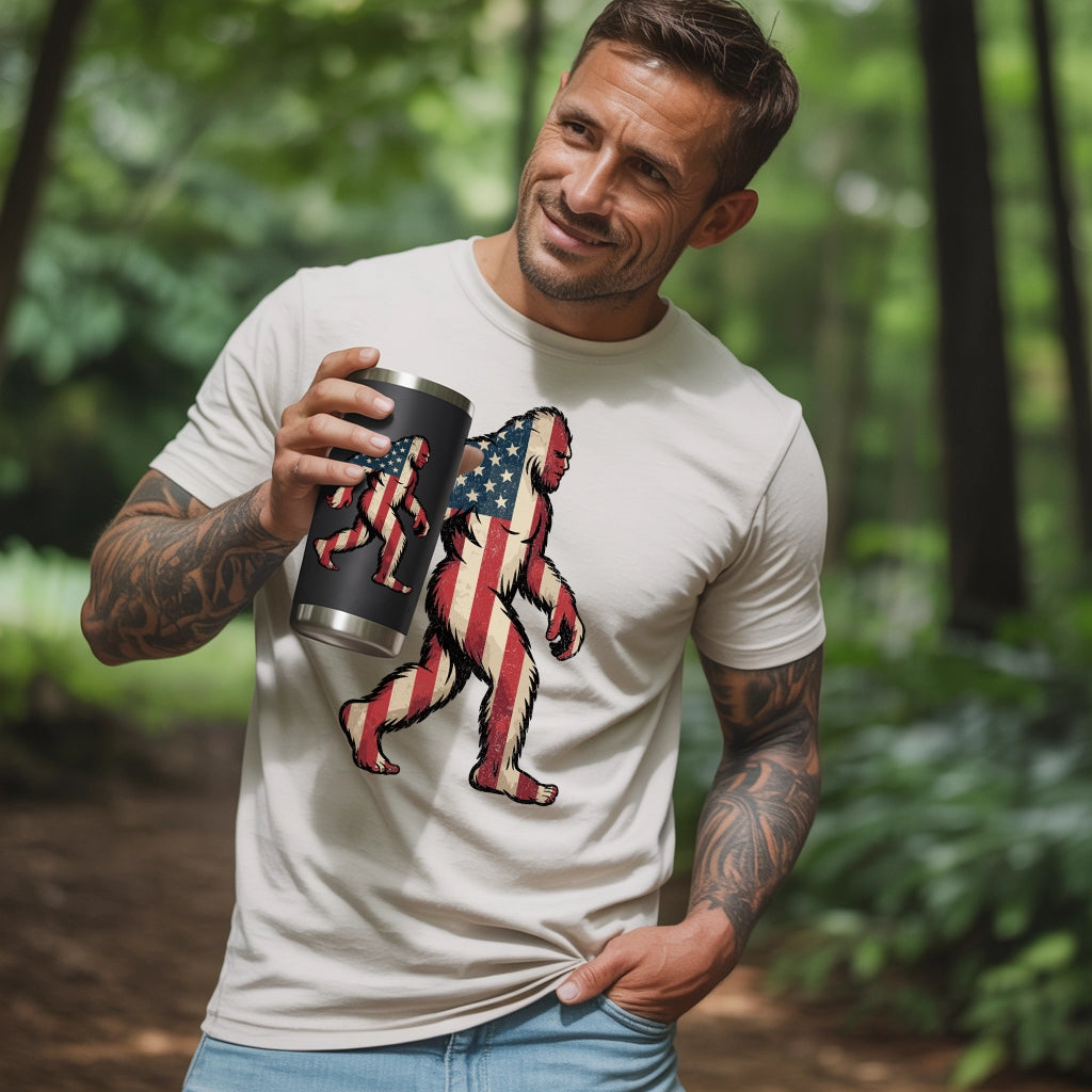 A guy wearing a American Flag Bigfoot. He is holding a tumbler with an American Big Foot on the mug.